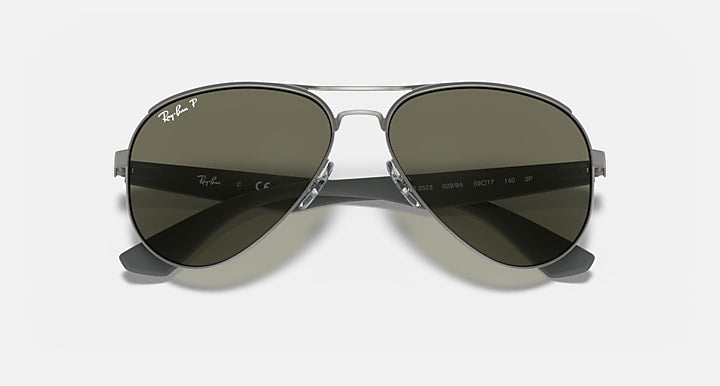 Aviator sunglasses with dark green gradient lenses and metal frame bridge detail