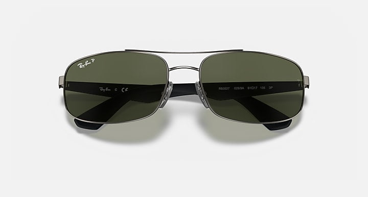 Sunglasses with dark green mirrored lenses, black frame, and metal bridge