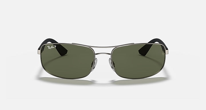Sunglasses with dark green lenses, thin metal rims, and black top accents