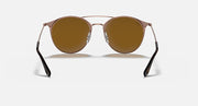 Round sunglasses with rose-gold bridge and dark brown tinted lenses
