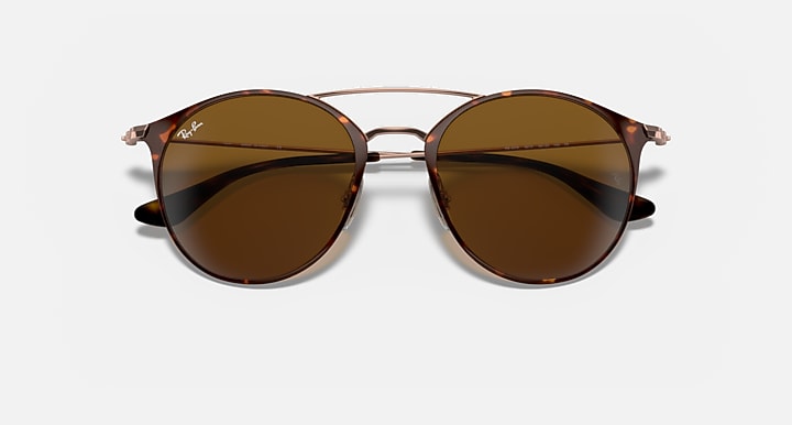 Round sunglasses with glossy brown lenses and tortoise-look temples