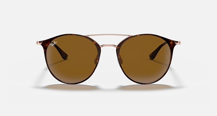 Round brown sunglasses with thin rose-gold frame and tinted amber lenses