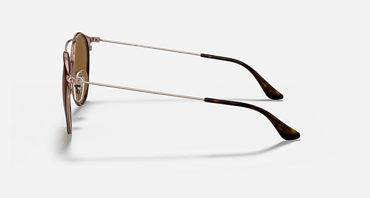 Sunglasses with rose-gold metal arms and black-tipped temples