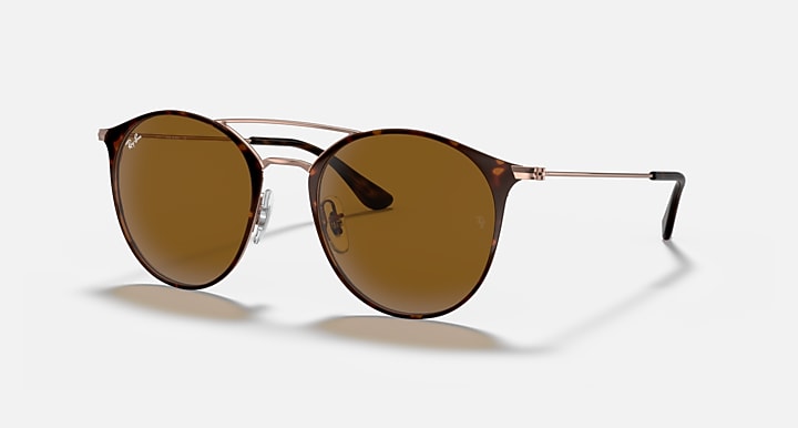 Round sunglasses side view, rose-gold frame with amber tinted lenses