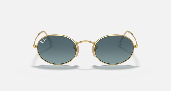 Gold round sunglasses with deep green lenses, front close-up