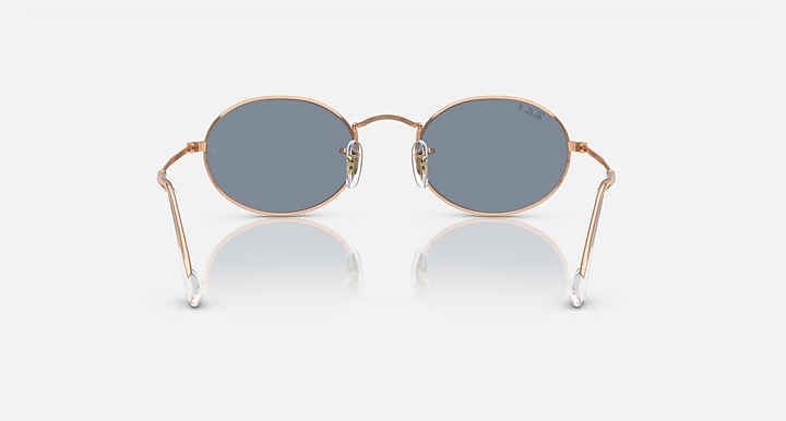 Ray-Ban round sunglasses with blue-gray lenses and rose gold metal frame, symmetrical front