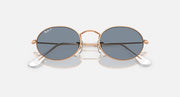 Ray-Ban round sunglasses with blue-gray lenses and rose gold metal frame, angled front view