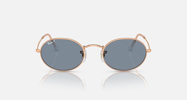 Ray-Ban round sunglasses with blue-gray lenses and rose gold metal frame, front view