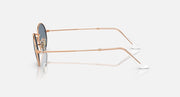 Ray-Ban round sunglasses with blue-gray lenses and rose gold metal frame, temple side view