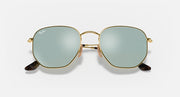 Hexagonal flat sunglasses with gold frame and light blue tinted lenses, front view