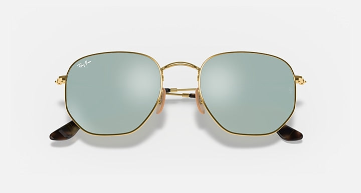 Hexagonal flat sunglasses with gold frame and light blue tinted lenses, front view