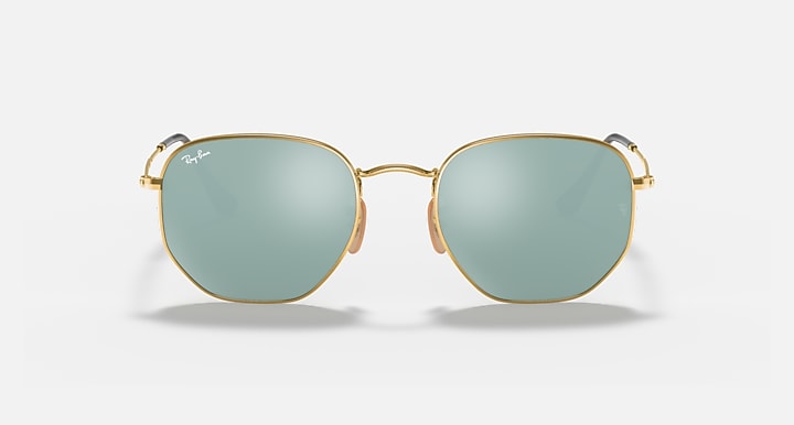 Hexagonal flat sunglasses with gold frame and light blue tinted lenses, front view