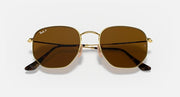 Ray-Ban hexagonal flat sunglasses with dark brown lenses and gold frame, front view