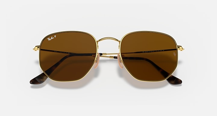 Ray-Ban hexagonal flat sunglasses with dark brown lenses and gold frame, front view