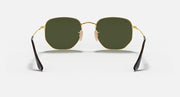 Hexagonal flat sunglasses with gold frame and dark green lenses, center bridge