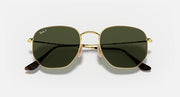 Hexagonal flat sunglasses with gold frame and dark green mirror lenses, angled view