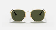 Hexagonal flat sunglasses with gold frame and dark green lenses, front view