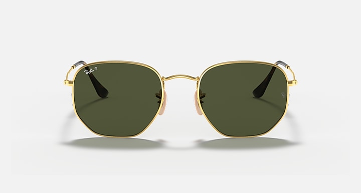 Hexagonal flat sunglasses with gold frame and dark green lenses, front view