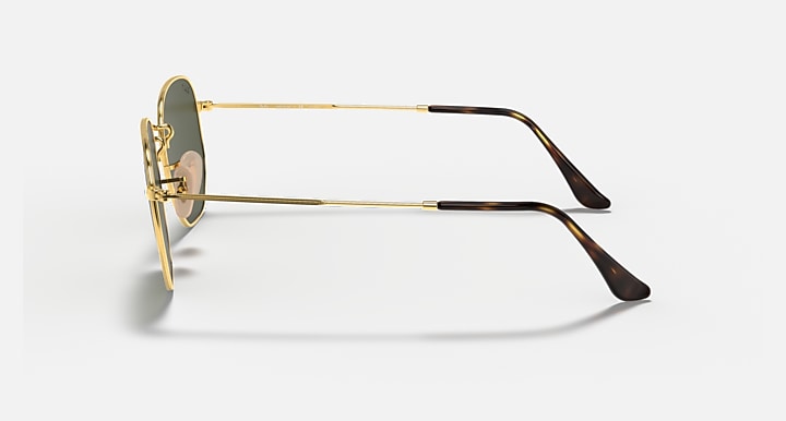 Hexagonal flat sunglasses, gold frame with dark green lenses, side profile