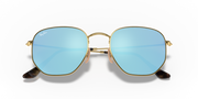 Ray-Ban hexagonal flat sunglasses with gold frame and pale blue gradient lenses