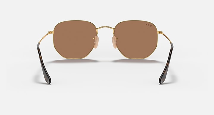 Ray-Ban hexagonal flat sunglasses with brown lenses and gold frame, front view