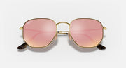 Ray-Ban hexagonal flat sunglasses with rose-pink lenses and gold frame, close front