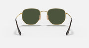 Hexagonal flat sunglasses with gold frame, dark temples, dark green tinted lenses
