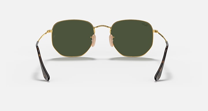 Hexagonal flat sunglasses with gold frame, dark temples, dark green tinted lenses