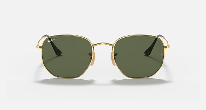 Hexagonal flat sunglasses with gold frame and dark green tinted lenses, front view