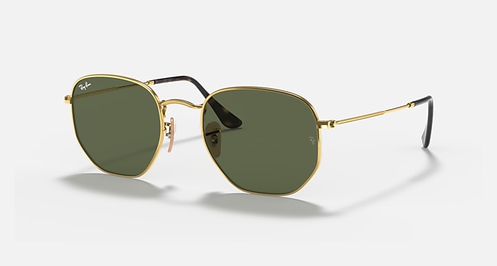 Hexagonal flat sunglasses with gold frame and dark green tinted lenses