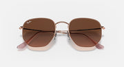 Ray-Ban hexagonal sunglasses with rose-gold frame and dark brown lenses