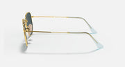 Ray-Ban hexagonal flat sunglasses, side view, gold metal frame with blue-tint lenses