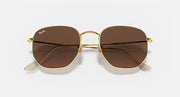 Hexagonal flat sunglasses with gold frame and brown mirror lenses, top angle