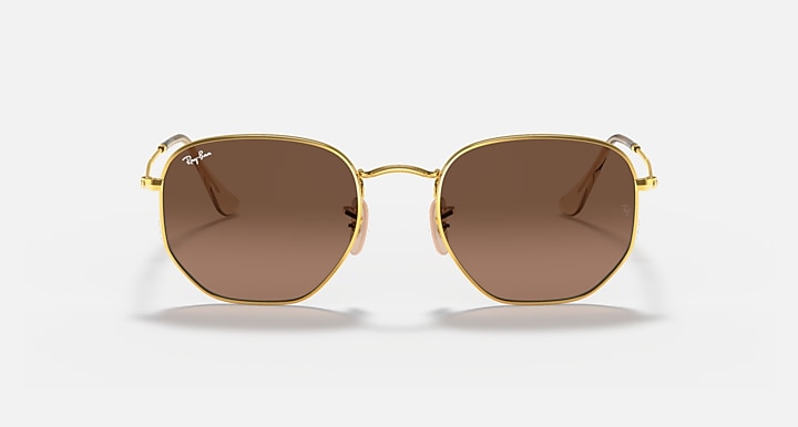 Hexagonal flat sunglasses with gold frame and brown lenses, front view