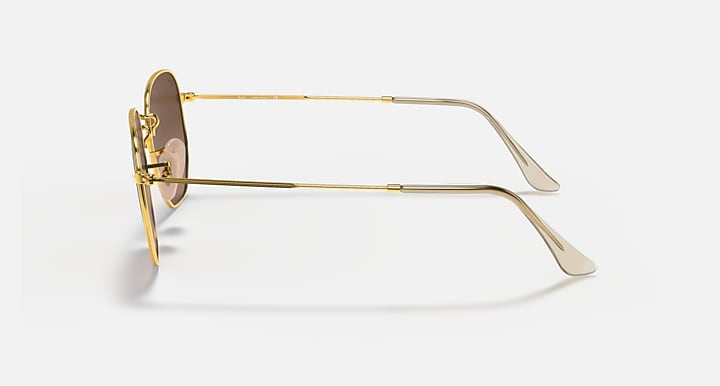 Hexagonal flat sunglasses, gold frame with brown lenses, side profile
