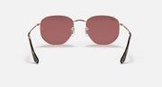 Rose gold hexagonal flat sunglasses front view with rose-tinted lenses and black tips