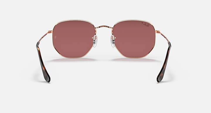 Rose gold hexagonal flat sunglasses front view with rose-tinted lenses and black tips