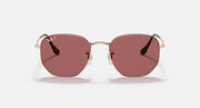 Rose gold hexagonal flat sunglasses with rose-tinted lenses and centered metal bridge