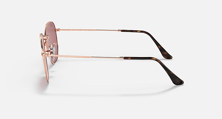 Rose gold hexagonal flat sunglasses side view with straight metal arms and dark tips