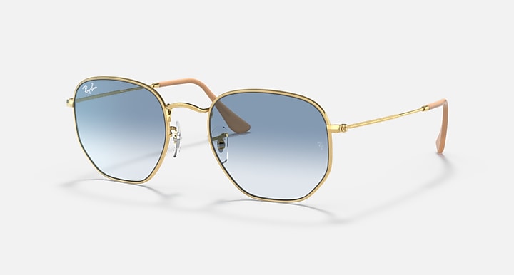 Hexagonal sunglasses, gold frame with blue gradient lenses and tan temples.