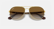 Ray-Ban aviator sunglasses with gold frame and brown gradient tinted lenses