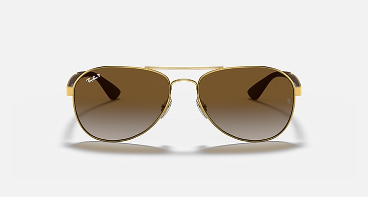 Ray-Ban aviator sunglasses with gold frame and dark brown gradient lenses