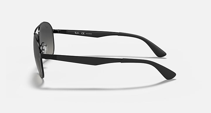 Aviator sunglasses with matte black frame and dark gray lenses, side view