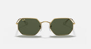 Octagonal sunglasses with gold frame and dark green lenses, front view