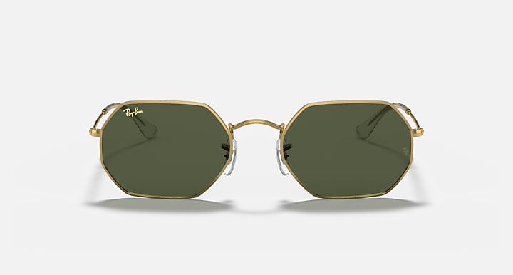 Octagonal sunglasses with gold frame and dark green lenses, front view