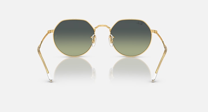 Ray-Ban round sunglasses with gold frame and muted green gradient lenses