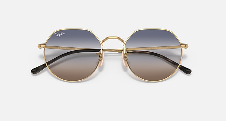 Round metal sunglasses with gold frame and dark blue-gray gradient lenses
