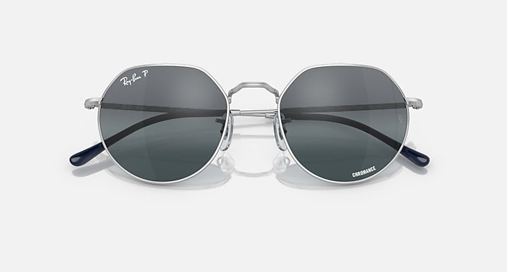 Round sunglasses with silver frame, dark gray lenses, and blue temple tips