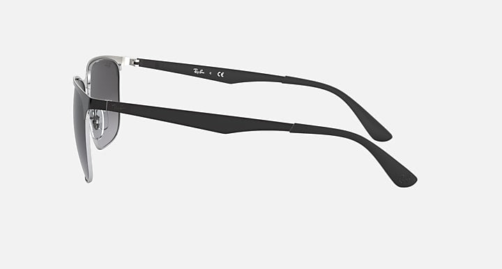 Sunglasses with dark gray lenses and black frame, side profile with curved temples