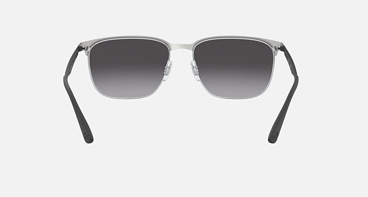 Sunglasses with dark gray gradient lenses and silver metal frame; front view